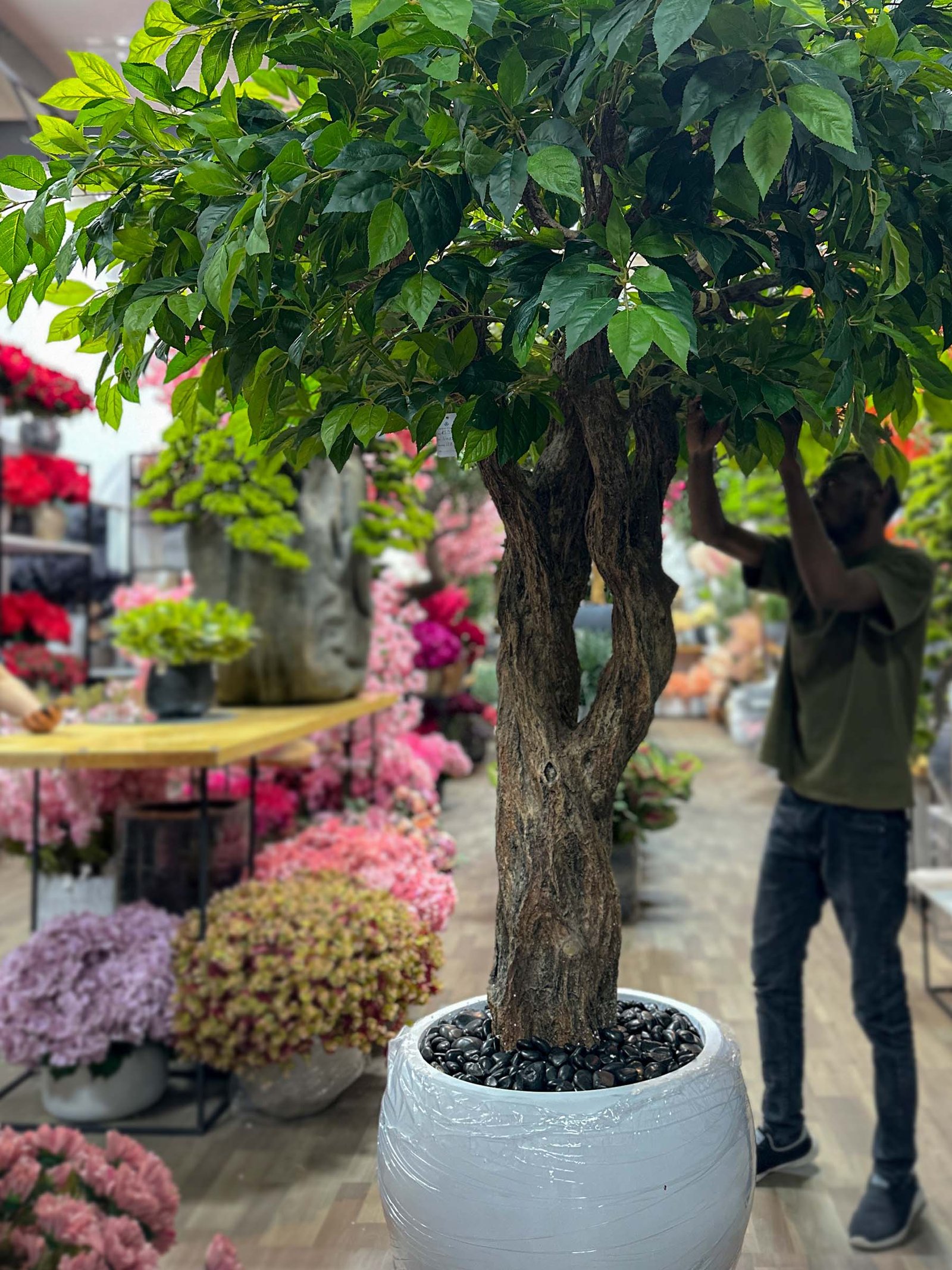 9346(2) Elevate any room with our realistic Artificial Greenery Tree, providing a maintenance-free touch of nature. Experience the difference in your space!